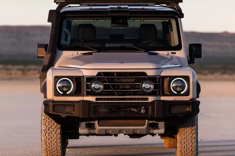 Front view of an INEOS Grenadier fitted with a roof platform and light bar